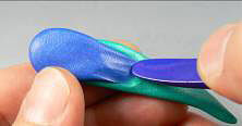 Blue and green clay being textured